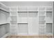 Custom walk-in closet with built-in shelving, drawers, and ample storage space at 3061 Bold Springs Rd, Dacula, GA 30019
