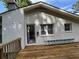 Exterior home view from backyard with a wooden deck and white brick with door at 453 James Street Sw, Lilburn, GA 30047