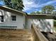 Exterior home view from backyard with a wooden deck and white brick at 453 James Street Sw, Lilburn, GA 30047