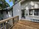 Exterior home view from backyard with a wooden deck and white brick with door at 453 James Street Sw, Lilburn, GA 30047