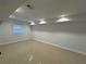 Spacious basement area with recessed lighting and tile flooring offers a clean and bright space at 453 James Street Sw, Lilburn, GA 30047