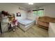 bedroom with laminate flooring, featuring a crib and a white platform bed at 453 James Street Sw, Lilburn, GA 30047