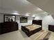 Bedroom with wood bed frame, dresser, mirror, area rug, and neutral paint at 453 James Street Sw, Lilburn, GA 30047