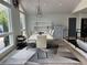 Bright dining area with modern decor, large windows, and easy access to the modern kitchen at 453 James Street Sw, Lilburn, GA 30047