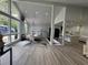 Elegant dining area with modern lighting, large windows, and a view of the landscaped front yard at 453 James Street Sw, Lilburn, GA 30047