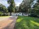 Charming one-story home with brick and siding accents, lush lawn, and an attached two-car garage at 453 James Street Sw, Lilburn, GA 30047
