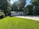 Charming one-story home with brick and siding accents, lush lawn, and an attached two-car garage at 453 James Street Sw, Lilburn, GA 30047