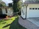 Garage exterior view, featuring a brick-paved walkway connecting the yard to the two-car garage at 453 James Street Sw, Lilburn, GA 30047