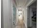Hallway with rooms that feature light walls and wood floors at 453 James Street Sw, Lilburn, GA 30047