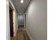 Hallway featuring light walls and dark wood flooring at 453 James Street Sw, Lilburn, GA 30047
