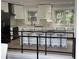 Modern kitchen with white cabinets, stainless steel appliances, and a large island with bar stool seating at 453 James Street Sw, Lilburn, GA 30047