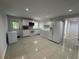 Eat-in kitchen featuring white cabinetry, appliances, tile flooring and natural light at 453 James Street Sw, Lilburn, GA 30047