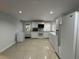 Eat-in kitchen featuring white cabinetry, appliances, tile flooring and natural light at 453 James Street Sw, Lilburn, GA 30047