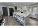 Modern kitchen featuring white cabinets, black appliances, and a large island with seating at 453 James Street Sw, Lilburn, GA 30047