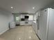 Eat-in kitchen featuring white cabinetry, appliances, tile flooring and natural light at 453 James Street Sw, Lilburn, GA 30047