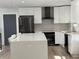 Modern kitchen features white cabinets, black stainless appliances, and a large center island at 453 James Street Sw, Lilburn, GA 30047