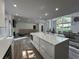 Bright living room with natural light, an open floor plan, and a modern kitchen at 453 James Street Sw, Lilburn, GA 30047