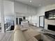 Bright open concept living area with modern kitchen and fireplace at 453 James Street Sw, Lilburn, GA 30047