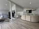 Open-concept living space showcasing the modern kitchen and living room with sleek finishes and neutral tones at 453 James Street Sw, Lilburn, GA 30047