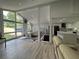 Bright open-concept living space featuring a modern kitchen and dining area with large windows at 453 James Street Sw, Lilburn, GA 30047