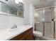 Cozy bathroom with a walk-in shower, toilet, a dark wood vanity and neutral-colored tile at 1213 Camelot Dr, Atlanta, GA 30349