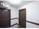 Hallway featuring two brown doors, an exit sign, and access to apartments at 1213 Camelot Dr, Atlanta, GA 30349