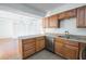 Kitchen featuring wood cabinets, stainless steel appliances, and an adjacent living area at 1213 Camelot Dr, Atlanta, GA 30349
