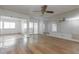 Inviting living room featuring hardwood floors, a large balcony door, and mirrored walls at 1213 Camelot Dr, Atlanta, GA 30349