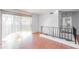 Open living room with hardwood floors, a sliding glass door with a view and a metal railing at 1213 Camelot Dr, Atlanta, GA 30349