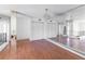 Spacious living room featuring wood floors, a mirrored wall, and an elegant chandelier at 1213 Camelot Dr, Atlanta, GA 30349