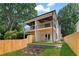 Expansive backyard with a wooden fence, lush lawn, stone retaining wall, and multi-level patios at 1238 Memorial Se Dr # A, Atlanta, GA 30316
