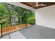 Covered balcony with wood ceiling, ceiling fan and iron railing overlooking a fenced backyard at 1238 Memorial Se Dr # A, Atlanta, GA 30316
