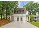 Modern home featuring a two-car garage, a mix of wood and white siding and a manicured front yard at 1238 Memorial Se Dr # A, Atlanta, GA 30316