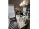 Bathroom vanity featuring double sinks, decorative items, and a well-lit mirror at 1346 Pilgrim Lake Dr, Cumming, GA 30040