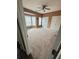 Spacious bedroom with carpet flooring, ceiling fan, and large windows offering natural light at 1346 Pilgrim Lake Dr, Cumming, GA 30040