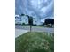 Exterior view of townhomes with green lawn, street view, and cloudy sky backdrop at 1346 Pilgrim Lake Dr, Cumming, GA 30040