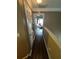 Hallway with wood flooring, neutral walls, and visible doorway leading to another room at 1346 Pilgrim Lake Dr, Cumming, GA 30040
