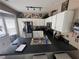 Spacious kitchen featuring white cabinets, a breakfast bar, and stainless steel appliances at 1346 Pilgrim Lake Dr, Cumming, GA 30040