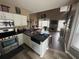 Open-concept kitchen with stainless appliances overlooking the living area at 1346 Pilgrim Lake Dr, Cumming, GA 30040