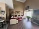 Bright living room with hardwood floors, sectional sofa, and large windows at 1346 Pilgrim Lake Dr, Cumming, GA 30040