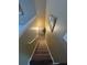 Carpeted staircase with railing leading upstairs, illuminated by a wall sconce at 1346 Pilgrim Lake Dr, Cumming, GA 30040