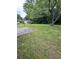View of backyard featuring grassy lawn and mature trees, showing a serene outdoor space at 1932 Pharrs Rd, Snellville, GA 30078