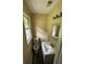 Bathroom featuring a toilet, single sink vanity, updated lighting, and plank flooring at 1932 Pharrs Rd, Snellville, GA 30078
