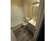 Bright bathroom featuring a shower-tub, modern vanity, stylish mirror, and wood-look flooring at 1932 Pharrs Rd, Snellville, GA 30078