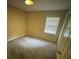 Bedroom featuring neutral walls, a window with blinds, carpeting, and closet at 1932 Pharrs Rd, Snellville, GA 30078