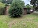 Modest one-story home featuring a brick facade, a large carport, and a grassy yard at 1932 Pharrs Rd, Snellville, GA 30078
