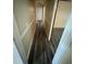 Hallway featuring plank flooring, white doors and trim, and beige walls at 1932 Pharrs Rd, Snellville, GA 30078