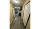 Hallway featuring plank flooring, white doors and trim, and beige walls at 1932 Pharrs Rd, Snellville, GA 30078