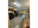 Kitchen with a range, refrigerator, wood cabinets, sink, and plank flooring at 1932 Pharrs Rd, Snellville, GA 30078
