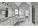 Bathroom with double vanity, gray tile accent, soaking tub, and glass shower at 5036 Weatherstone Drive, Buford, GA 30519